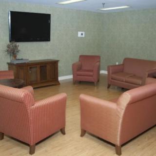 A cozy seating area with armchairs and a television.