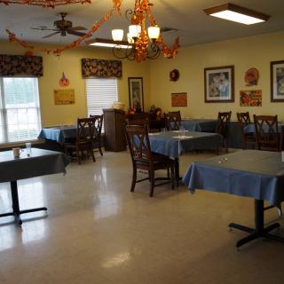 An empty dining room with decorated tables and chairs.