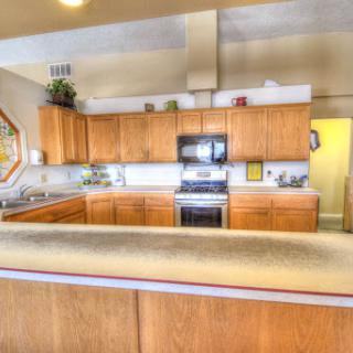 A spacious and modern kitchen featuring wooden cabinets and sleek appliances.