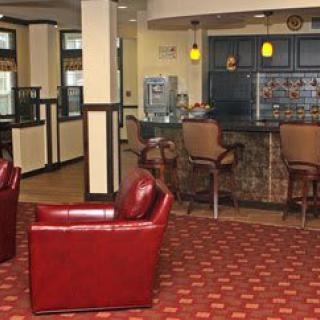 A cozy lobby area with leather seating and a small bar counter.