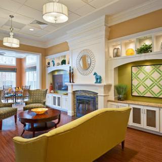 A stylish and welcoming lounge area featuring comfortable seating, modern decor, and warm lighting.