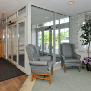A welcoming lobby with comfortable chairs and glass doors.