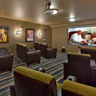 A cozy home theater featuring comfortable recliner seating and a large screen for an immersive viewing experience.