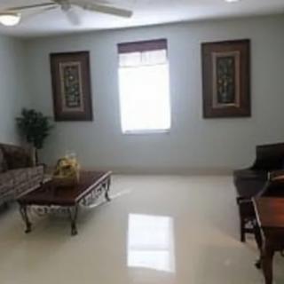 A spacious living room with elegant furniture and decor.