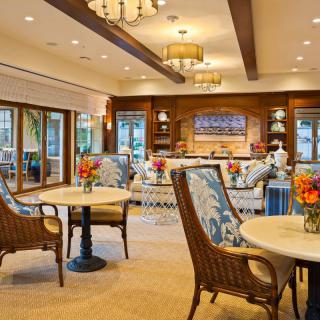 A cozy and well-decorated living area featuring comfortable seating, tables, and ambient lighting.