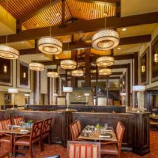 A stylish restaurant interior featuring elegant lighting and comfortable seating.