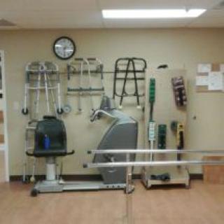 A physical therapy room equipped with various rehabilitation tools and exercise equipment.