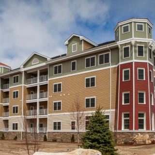 A modern multi-story residential building with a unique architectural design.