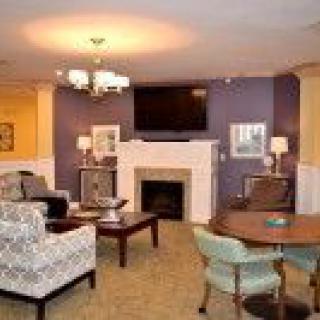 A cozy living room with a fireplace, television, and comfortable seating.