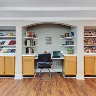 A cozy home office setup with bookshelves and a desk.