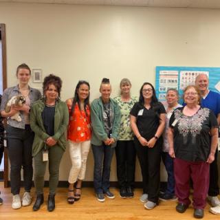 A dedicated team of healthcare professionals posing together in a warm and friendly environment.