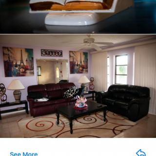 A cozy living room with leather sofas, a coffee table, decorative artwork, and lamps.