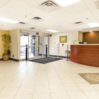 A spacious lobby area with a reception desk and entrance.