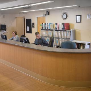 A reception area with two employees at their workstations.