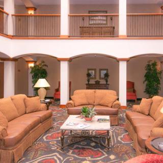 A spacious hotel lobby with comfortable seating and elegant decor.