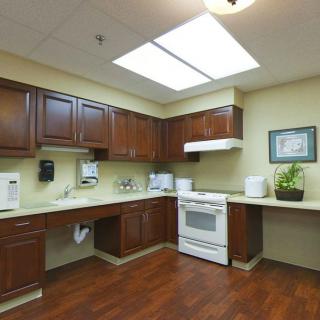 A clean and modern kitchen with wooden cabinets and a white stove.