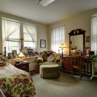 A cozy bedroom with vintage decor and ample natural light.
