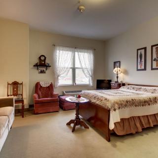 A cozy vintage-style bedroom with classic furniture and decor.