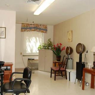 An interior view of a salon with chairs, hair dryers, and decorative elements.