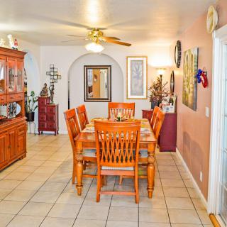 A cozy dining room with wooden furniture and decorative elements.