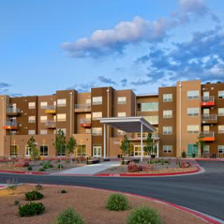A modern apartment complex with landscaped grounds and a welcoming entrance.