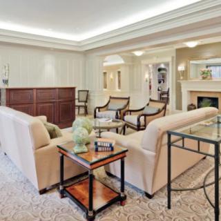 A luxurious and cozy living room featuring elegant furniture, a fireplace, and modern decor.