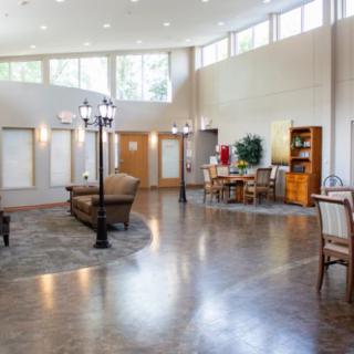 A spacious and well-lit living room with modern furniture and hardwood flooring.