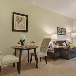 A cozy living and dining area with elegant furniture and warm lighting.