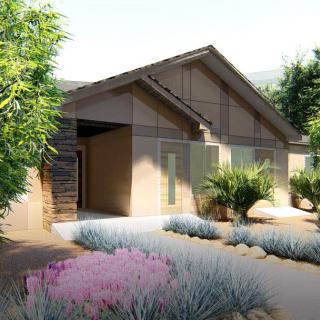 A modern single-story house with landscaped surroundings and a pathway.