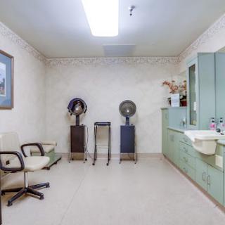 A clean and minimalistic medical waiting area with chairs and equipment.