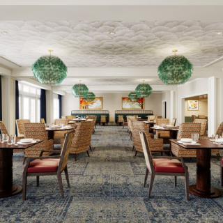 Elegant dining area of a restaurant with stylish chandeliers and well-arranged tables.