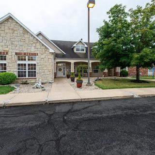 A suburban house with a stone facade and well-maintained landscaping.