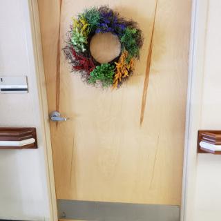 A beautifully decorated door adorned with a colorful wreath, inviting warmth and charm.