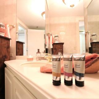 A neatly arranged bathroom countertop with toiletries and towels.