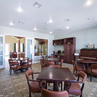 A spacious and well-lit dining area with wooden tables and chairs.