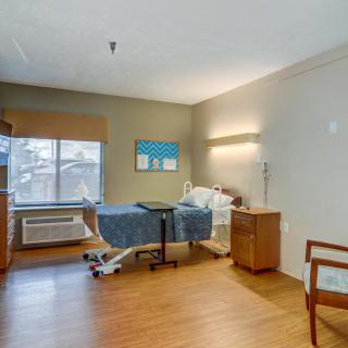 A well-equipped hospital room with a single bed and modern amenities.