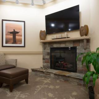 A cozy living room with a fireplace, television, and comfortable seating.