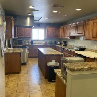 Spacious kitchen with wooden cabinetry and a central island.