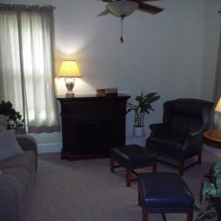 A cozy living room with comfortable seating and warm lighting.