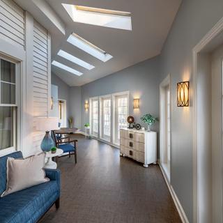 A modern hallway with skylights and elegant decor.