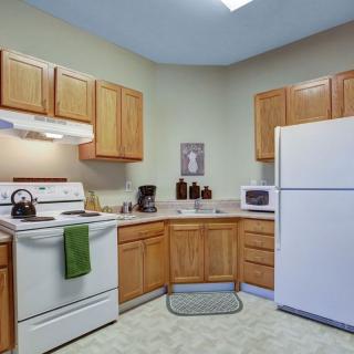 A cozy kitchen with wooden cabinets and modern appliances.