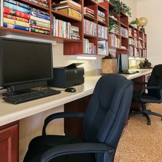 A well-organized office space with computers and bookshelves.
