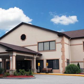 A hotel building with a clear sky and entrance area.