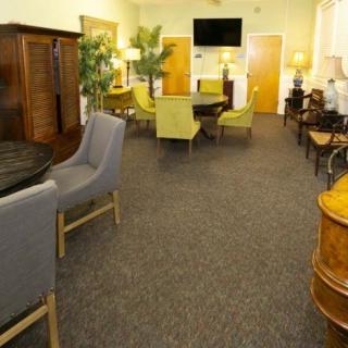 A cozy lounge area with various seating options, tables, and decorative plants.
