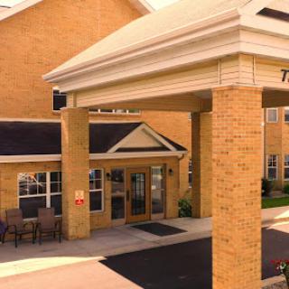 Welcoming entrance of a brick hotel.