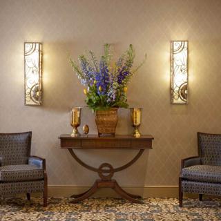 Elegant lobby area with floral arrangement and ambient lighting.