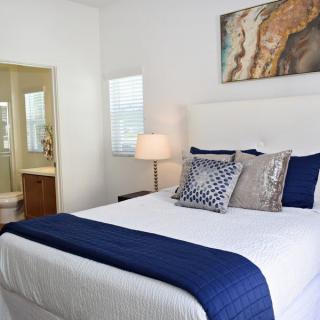 A modern bedroom with blue accents and stylish decor.