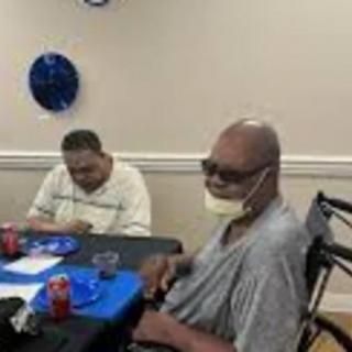 Two people sitting at a table, enjoying a meal during a celebration.
