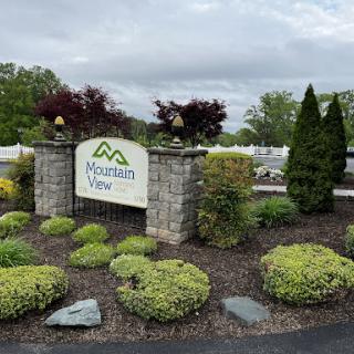 Entrance sign to Mountain View, surrounded by well-maintained landscaping.