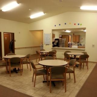 A spacious dining area with tables and chairs arranged neatly.